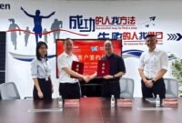 Photo&nbsp;of&nbsp;the&nbsp;two&nbsp;parties&nbsp;signing&nbsp;the&nbsp;agreement